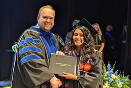 Paola Lopez Cervantes receives her Associate in Arts degree with High Honors from Dr. Brian S. Merritt, MTCC President.