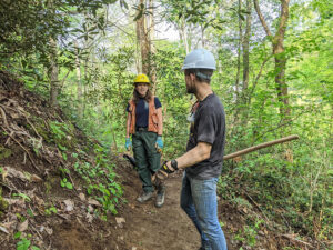 workers constructing trail with hand tools