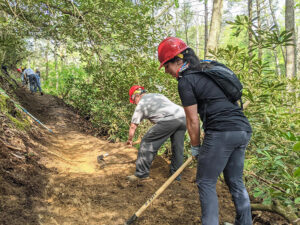 workers constructing trail with hand tools