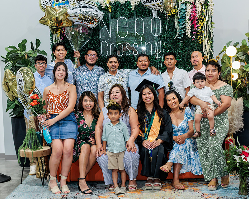 graduates posing with their families in 2024
